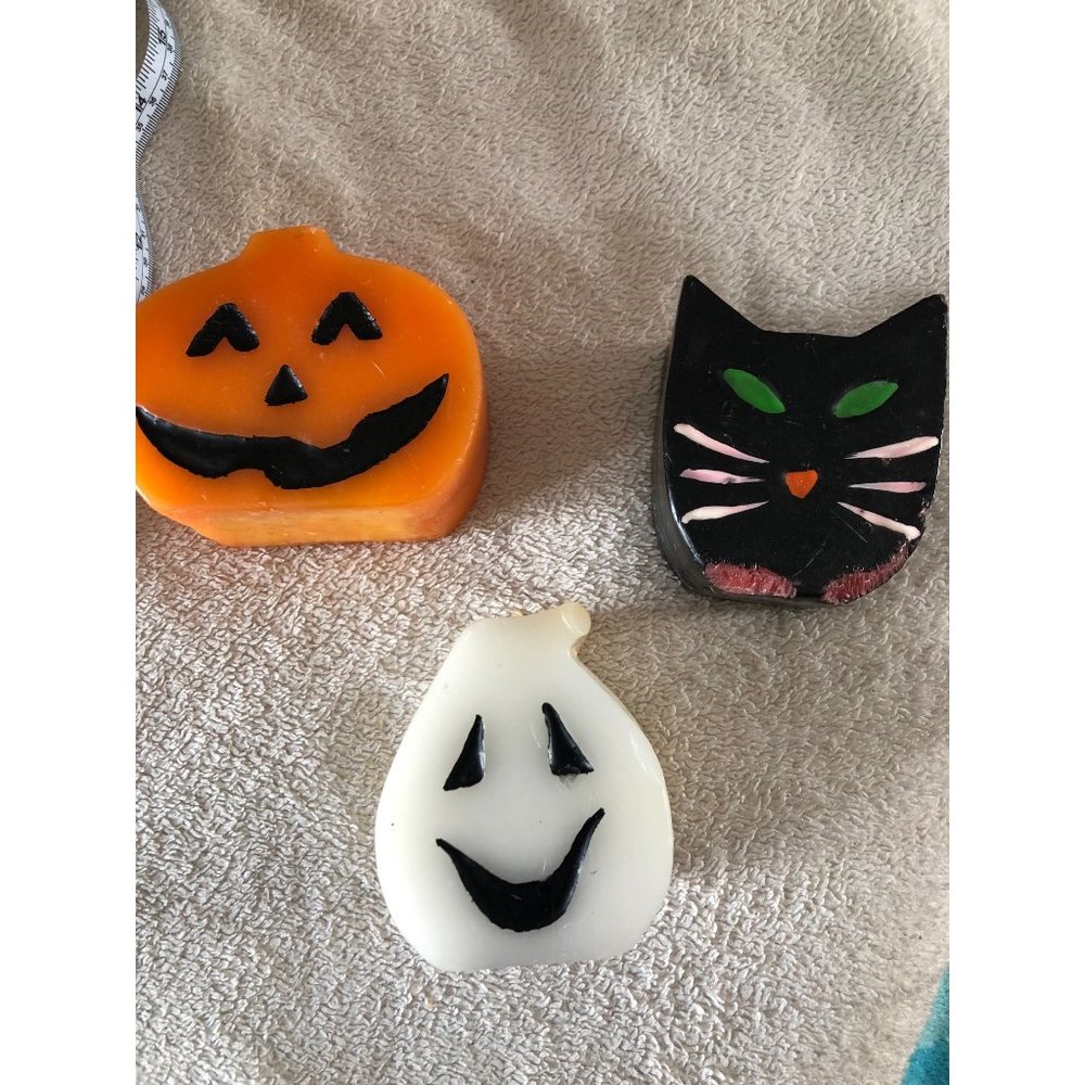 Halloween cat, ghost, and pumpkin candles